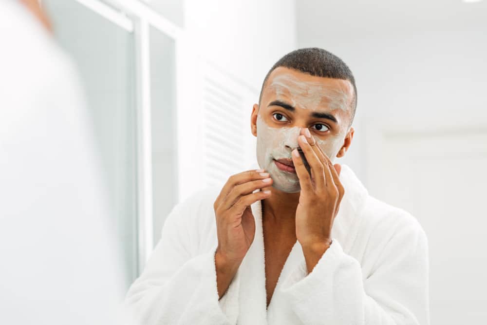 man applying a clay mask