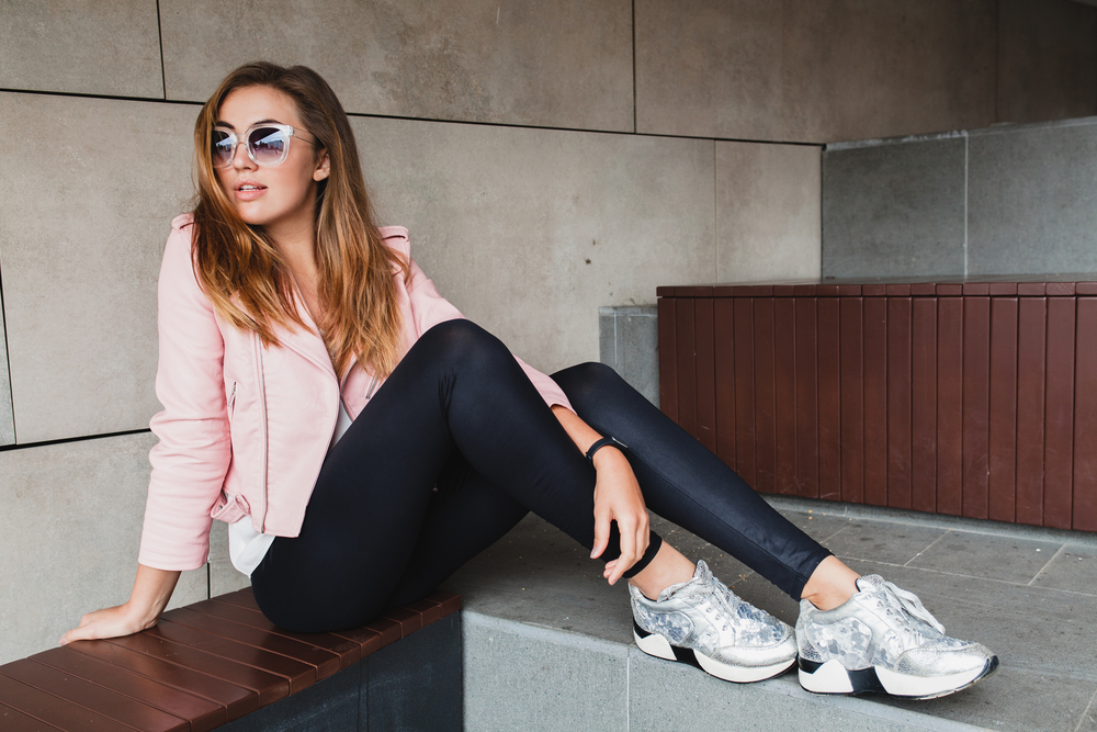 young woman in leggings pink jacket