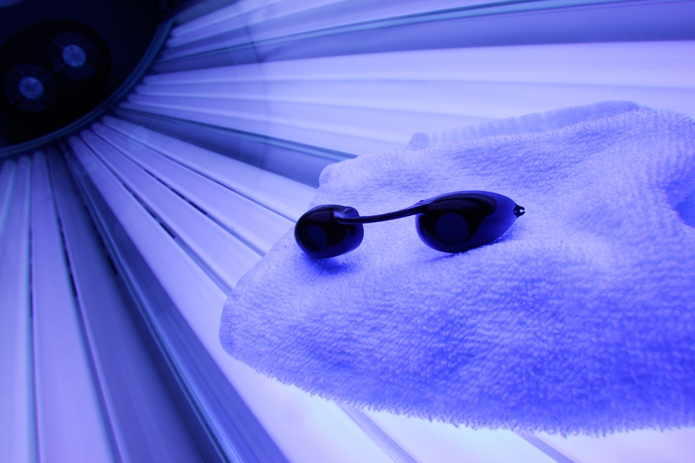 towel and goggles in tanning bed