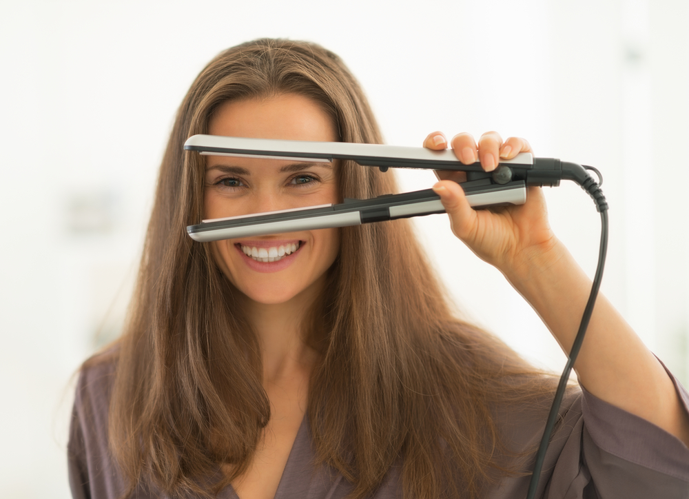 woman looking through hair straightener